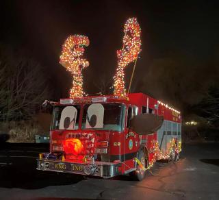Red fire truck with antlers, eyes and nose to look like rudolph the red nosed reindeer